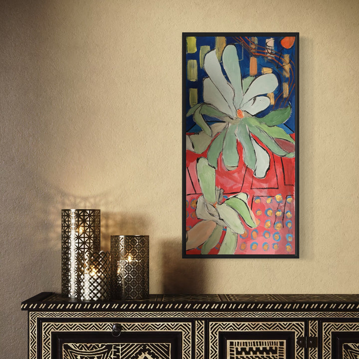 The artwork 'Spring Pushes Up Against the Windows' features a bold floral composition with a large abstract flower in soft mint greens and whites against a vibrant backdrop of navy blue and coral pink. The geometric pattern in the background creates a stained-glass effect, while textured brushstrokes in acrylic showcase a modern botanical interpretation. By Owen Brown.