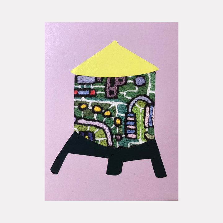 The artwork 'Water Tower 58' by Ann Cofta features a stylized water tower shape in collaged paper against a soft pink background. The tower's body displays an intricate mosaic-like pattern in green, yellow, blue, and white, suggesting an abstract cityscape or map. The structure has a distinctive yellow triangular top and stands on black angular legs, creating a modern, geometric composition.