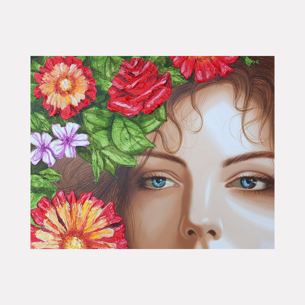 The artwork 'Amapola III' features a partial view of a face surrounded by vibrant floral elements, including red roses, coral-orange gerbera daisies, and delicate purple blooms against lush green foliage. The acrylic painting on wood showcases detailed brushwork and a striking botanical composition by Carlos Gamez de Francisco.