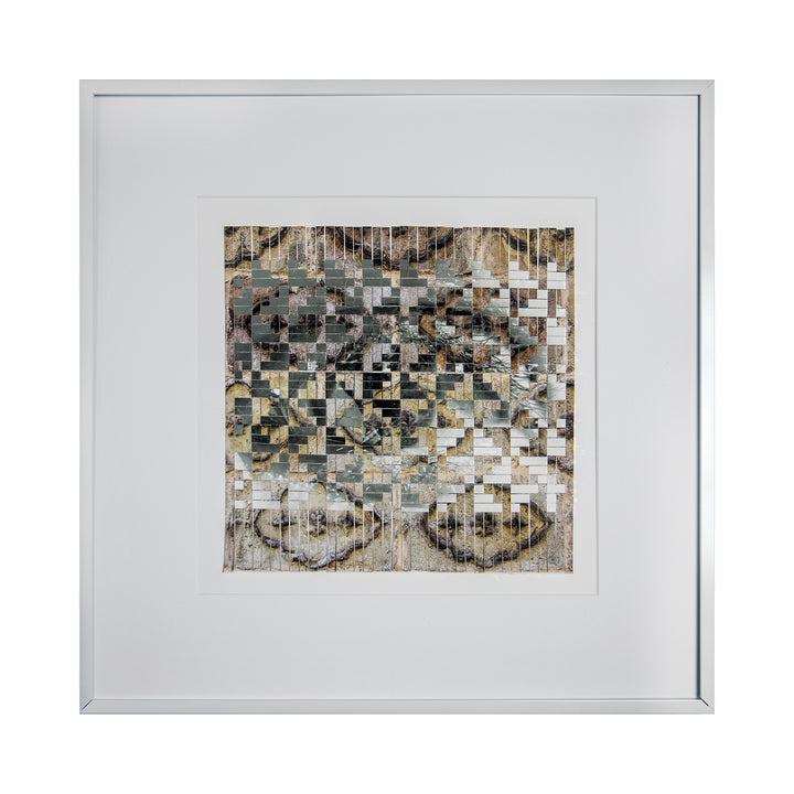 The artwork 'Blending In' by Kiana Honarmand features a pixelated mosaic pattern created from hand-cut and woven giclee prints. The composition displays a gradient of earth tones, from beige to gray, arranged in geometric squares that create an abstract, digitally-inspired aesthetic. Framed in white, this 18x18 inch piece combines traditional weaving techniques with modern digital art elements.