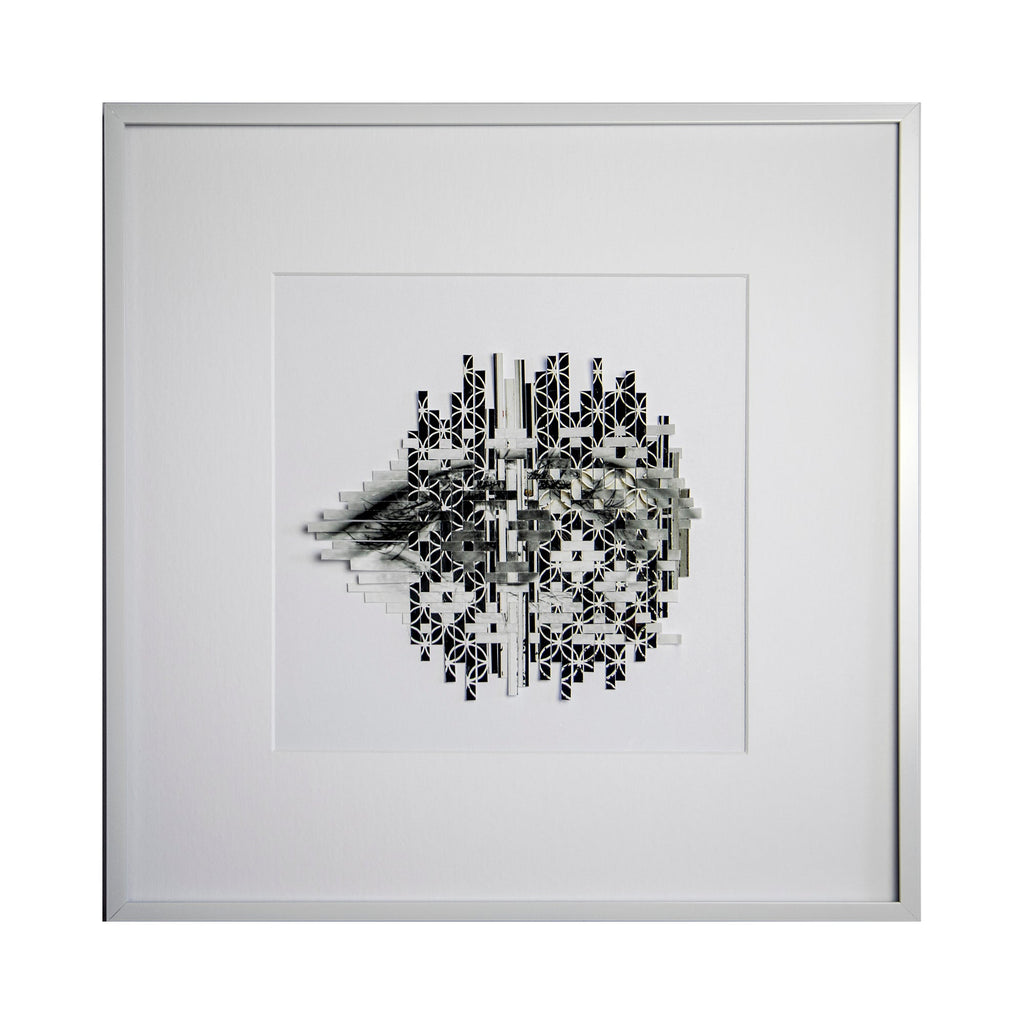 The artwork 'Bolted' by Kiana Honarmand features an intricate black and white circular pattern created from hand-cut and woven giclee prints. The design resembles a fragmented mandala with geometric elements and bolt-like shapes radiating from the center, displayed in a crisp white frame. The monochromatic composition creates a striking contrast with delicate details and shadow effects. By Kiana Honarmand.