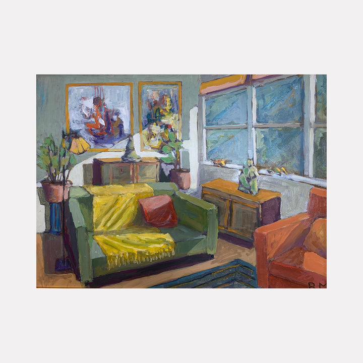 Bonnies Couch by Roger McErlane depicts a cozy interior scene with a sage green couch adorned with a vibrant yellow throw blanket. Two framed artworks hang on pale walls, while natural light streams through a large window. An orange armchair and potted plants add warmth to this impressionistic oil painting, showcasing loose brushstrokes and rich color harmonies.