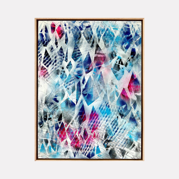 The artwork 'Daylight' by Ann Tarantino features an abstract composition of fractured geometric shapes in vibrant blues, magentas, and white. Dynamic triangular patterns create a crystalline effect across the laser-etched panel, with translucent layers of acrylic paint creating depth and movement. The 24x18 inch piece evokes shattered ice or refracted light.