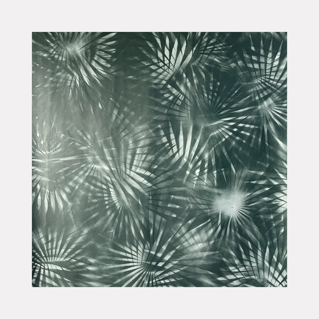 The artwork 'Exotique' features a mesmerizing pattern of radiating palm fronds in monochromatic sage green tones. Dynamic spray paint technique creates overlapping starburst effects, giving depth and movement to the tropical-inspired design. The 58x58 inch canvas showcases a modern, abstract interpretation of botanical elements. By Gina Iannucci.