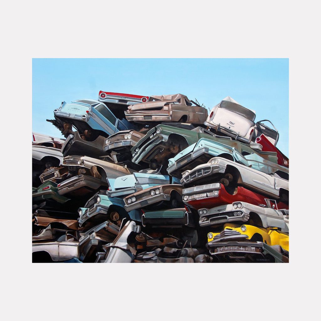 The artwork 'JUNKYARD' by Alex Devereux captures a towering pile of vintage crushed automobiles against a bright blue sky. The composition features stacked classic cars in various colors including turquoise, red, silver, and yellow, creating a dramatic study of automotive decay. The acrylic painting on canvas masterfully renders metallic textures and shadows within the compressed vehicles.