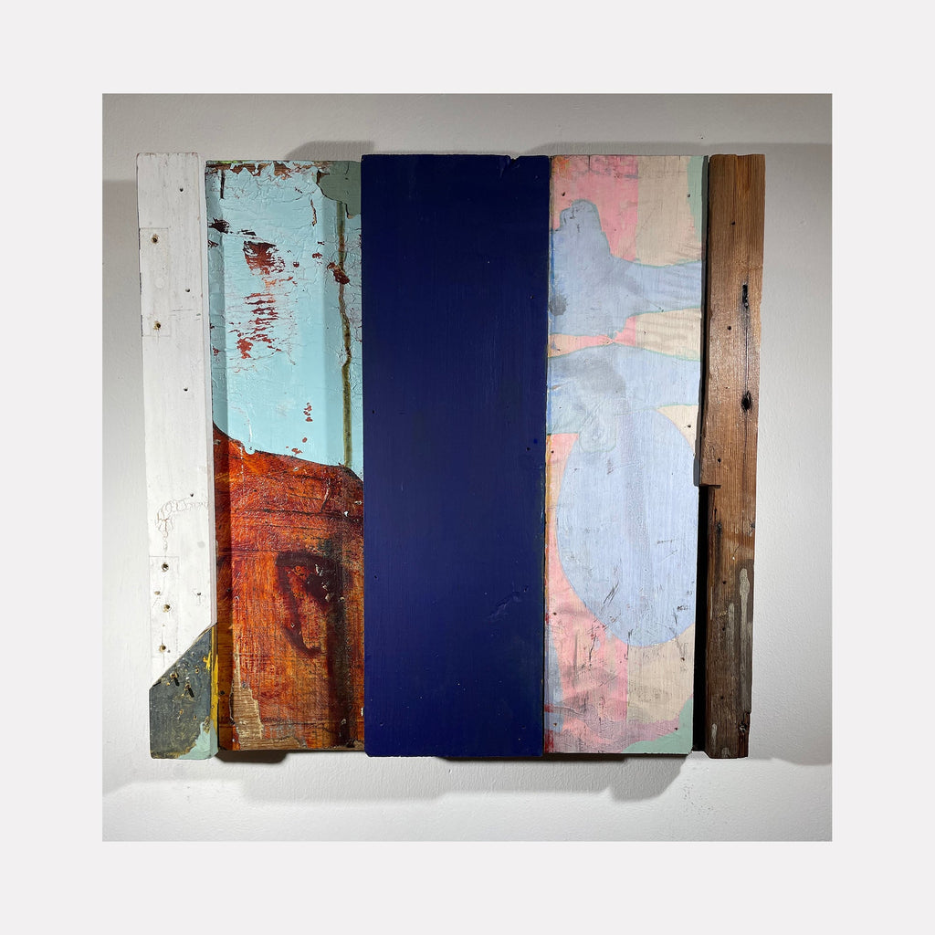 Kingston Shutter no. 27 by Simon Draper features a geometric abstract composition of reclaimed wood panels arranged vertically. The piece combines weathered textures with bold color blocks including deep navy blue, distressed turquoise, rustic rust-brown, and pale pink. The 16x16 painted wood assemblage showcases a harmonious blend of raw and refined surfaces.