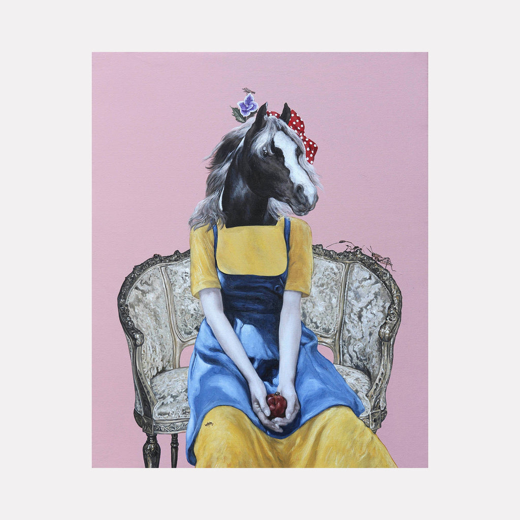 The artwork 'Red Apple in the Summer' by Carlos Gamez de Francisco features a surreal anthropomorphic figure with a horse's head wearing a classic blue dress and yellow cardigan, seated elegantly in an ornate vintage armchair against a soft pink background. The figure holds a red apple while adorned with a red polka dot bow, combining classical portraiture with contemporary surrealism on acrylic canvas.