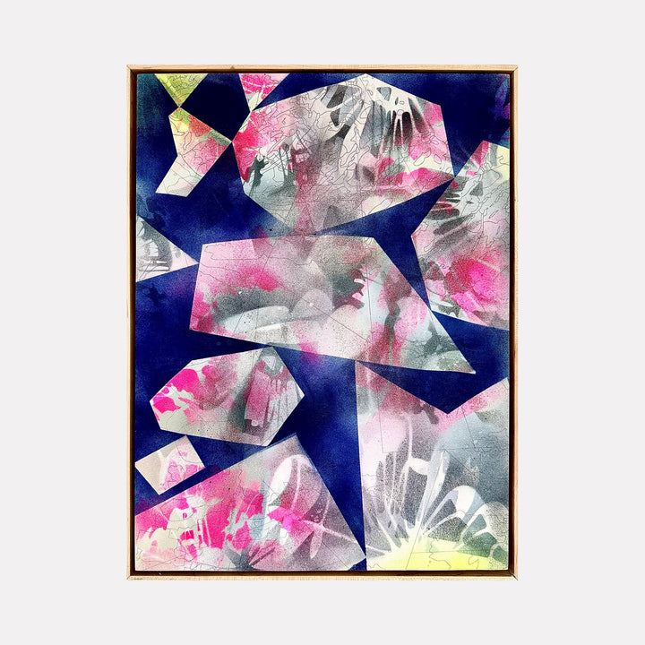 The artwork 'Sun Set' by Ann Tarantino features abstract geometric shapes floating on a deep navy background. Angular crystal-like forms in translucent pink, silver, and pale yellow create a dynamic composition. The laser-etched acrylic panel adds texture and depth, with splashes of vibrant fuchsia and subtle lime green accents overlapping throughout the 24x18 inch piece by Ann Tarantino.