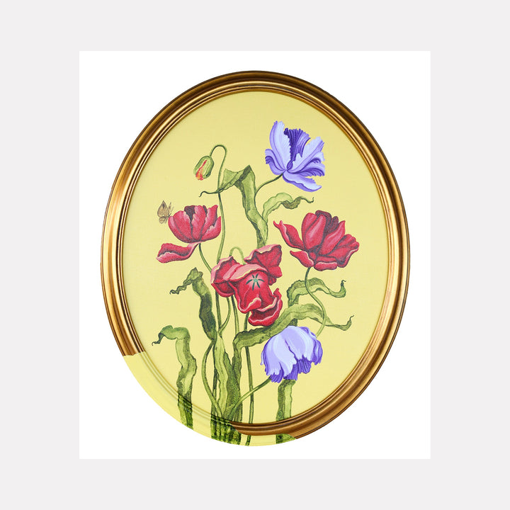 The artwork 'Tulips and Wings III' by Carlos Gamez de Francisco features delicate red tulips and purple iris blooms against a soft yellow background, presented in an oval golden frame. The botanical composition shows graceful green stems and leaves with a watercolor-like quality, created in acrylic on canvas, capturing the elegant interplay of floral elements.