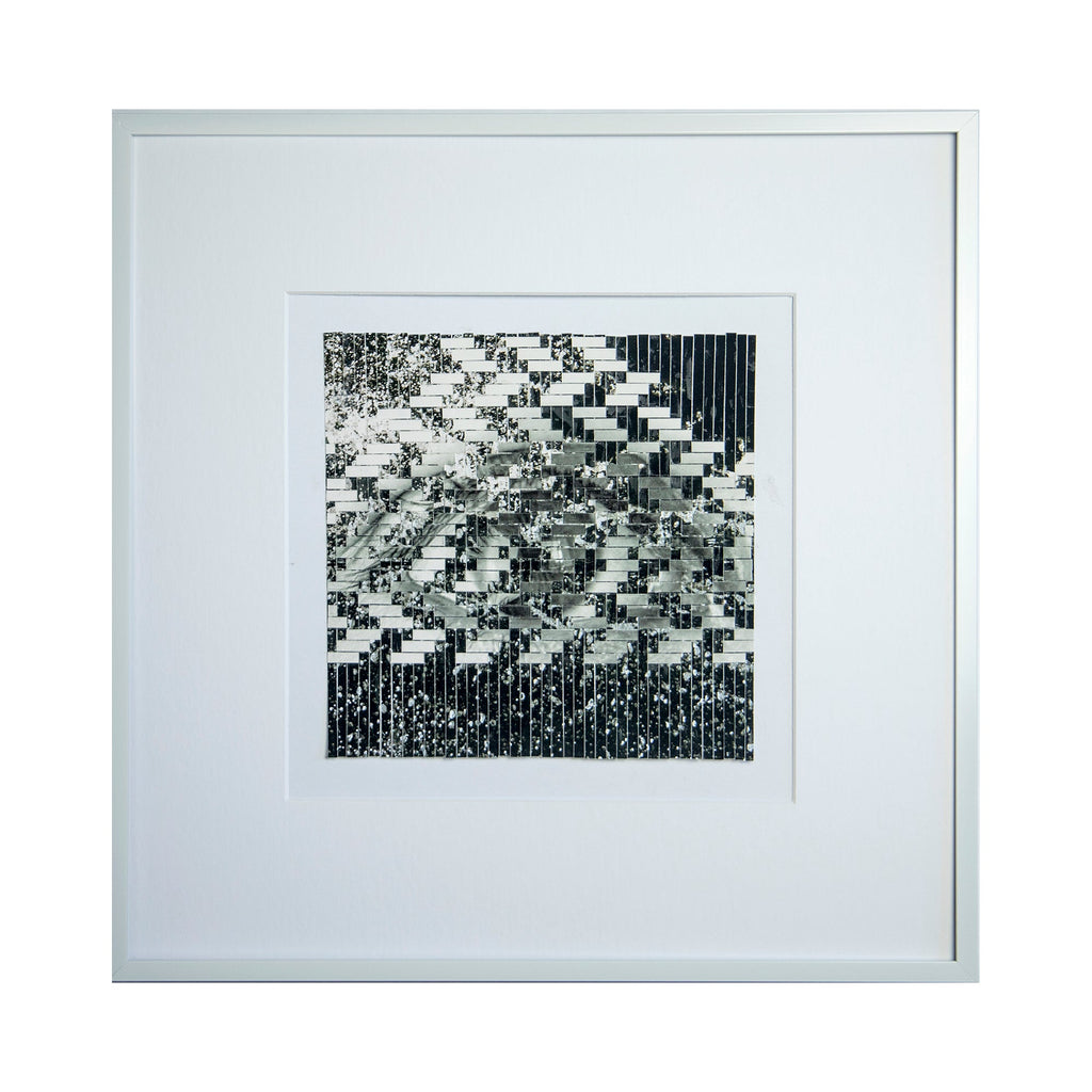 The artwork 'Waterfall' by Kiana Honarmand features an abstract geometric pattern of interwoven black and white strips creating a cascading effect. Hand-cut and woven giclee prints form a dynamic zigzag composition, reminiscent of falling water, mounted in a clean white frame. The 16x16 inch piece combines sharp contrasts and structured patterns for a modern minimalist aesthetic. By Kiana Honarmand.