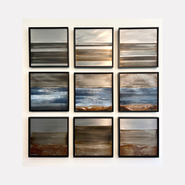 The artwork 'Where Land Meets Sky 9' by Nicki Adani features a striking nine-panel installation on steel, depicting abstract landscapes in muted earth tones and blues. Each square panel showcases horizontal bands of color suggesting horizons, with gradients transitioning from stormy grays to warm browns and deep ocean blues, creating a contemplative mixed media composition measuring 42x42 inches.