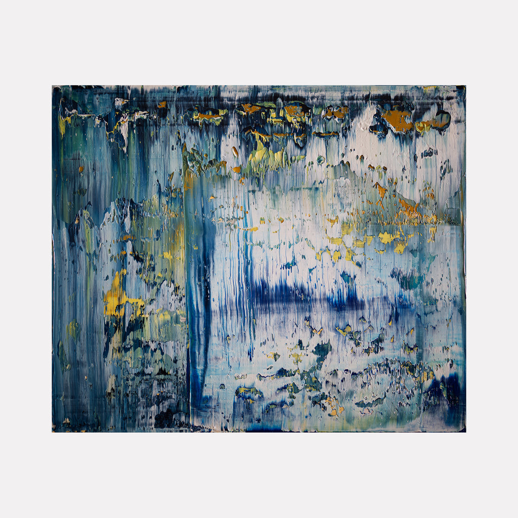 The artwork 'Abstract Indigo 1' by Harry Moody features dramatic vertical brushstrokes in deep indigo blue and white, with accents of golden yellow throughout. The textural oil painting creates a sense of cascading water or rain, with layered paint techniques creating depth and movement across the 24x20 inch canvas.