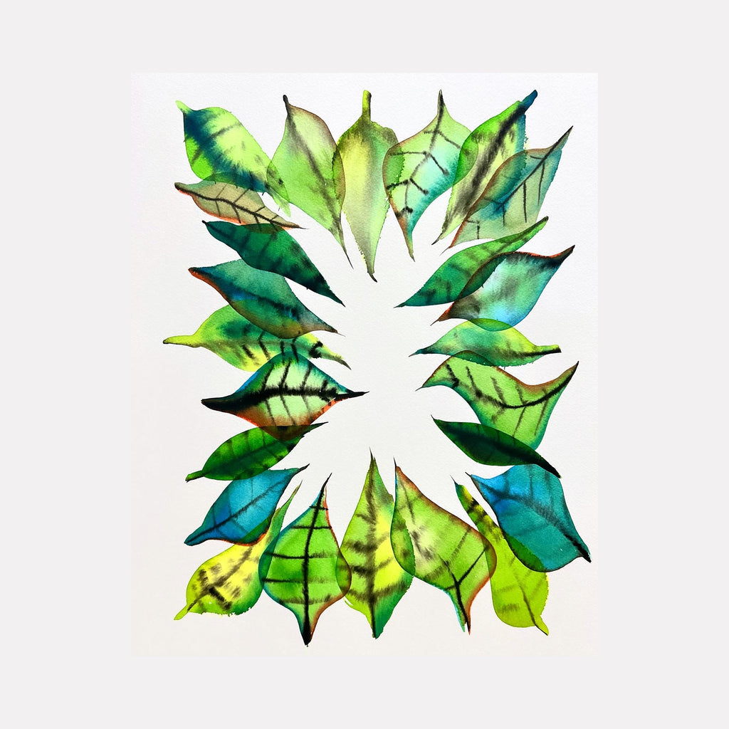 The artwork 'Coronet' features a symmetrical arrangement of watercolor leaves in varying shades of emerald, lime, and turquoise, forming a radial pattern against a white background. Each leaf displays intricate vein details and translucent botanical effects created with archival ink. By Monica Carrier.