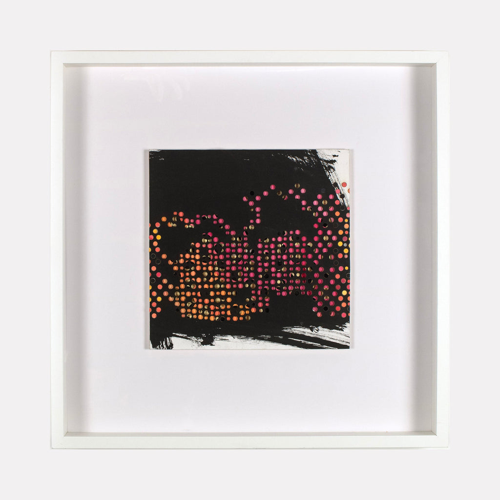 The artwork 'Innos' by Margaret Griffith features a mesmerizing pattern of vibrant dots in pink, orange, and red hues arranged in organic, flowing formations against a deep black background. The dotted design creates an abstract, pixelated effect, framed by bold brushstrokes of black paint on cut paper. The piece is elegantly presented in a crisp white frame.