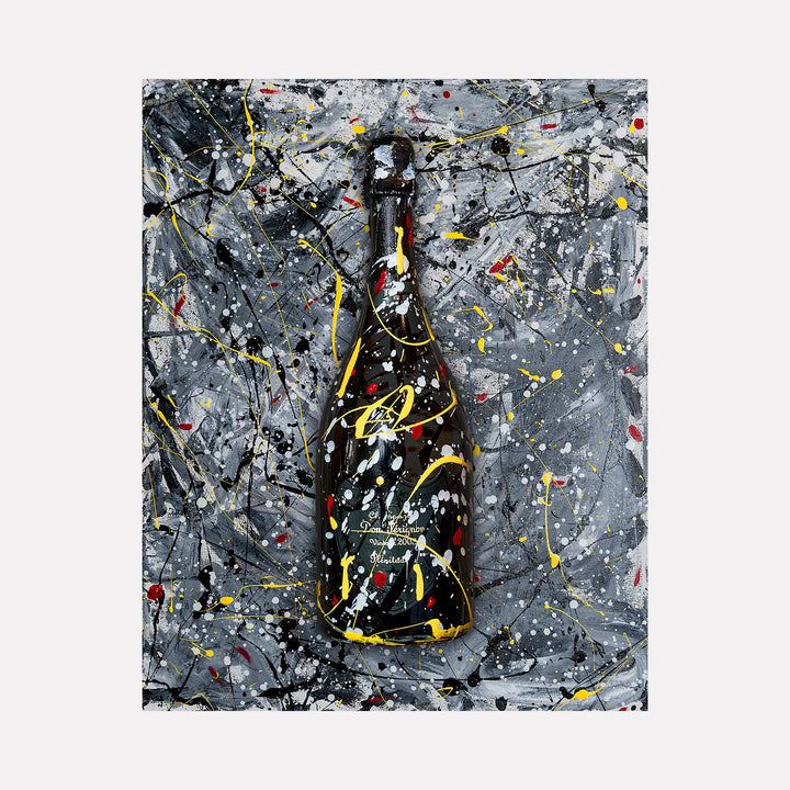 The artwork 'P-203' by Jean-Remi Barbier features a dramatic champagne bottle silhouette against a stormy gray background, adorned with dynamic splashes of yellow, red, and white paint in an abstract expressionist style. The composition creates a vibrant contrast between the dark bottle form and energetic paint splatters. Limited edition digital photography by Jean-Remi Barbier.