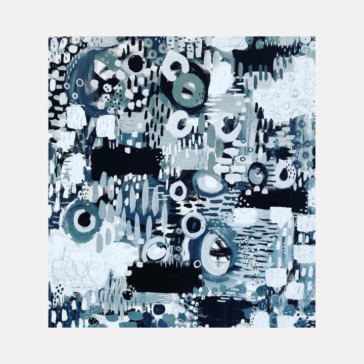 The artwork 'Pixelated Rainy Rooftop' features an abstract composition of circles and geometric shapes in various shades of blue, white, and black. The dynamic pattern suggests falling rain through a digitized lens, with dripping effects and scattered circular forms resembling water droplets. Created with acrylic, gesso, and ink by Alexandra Jamieson.