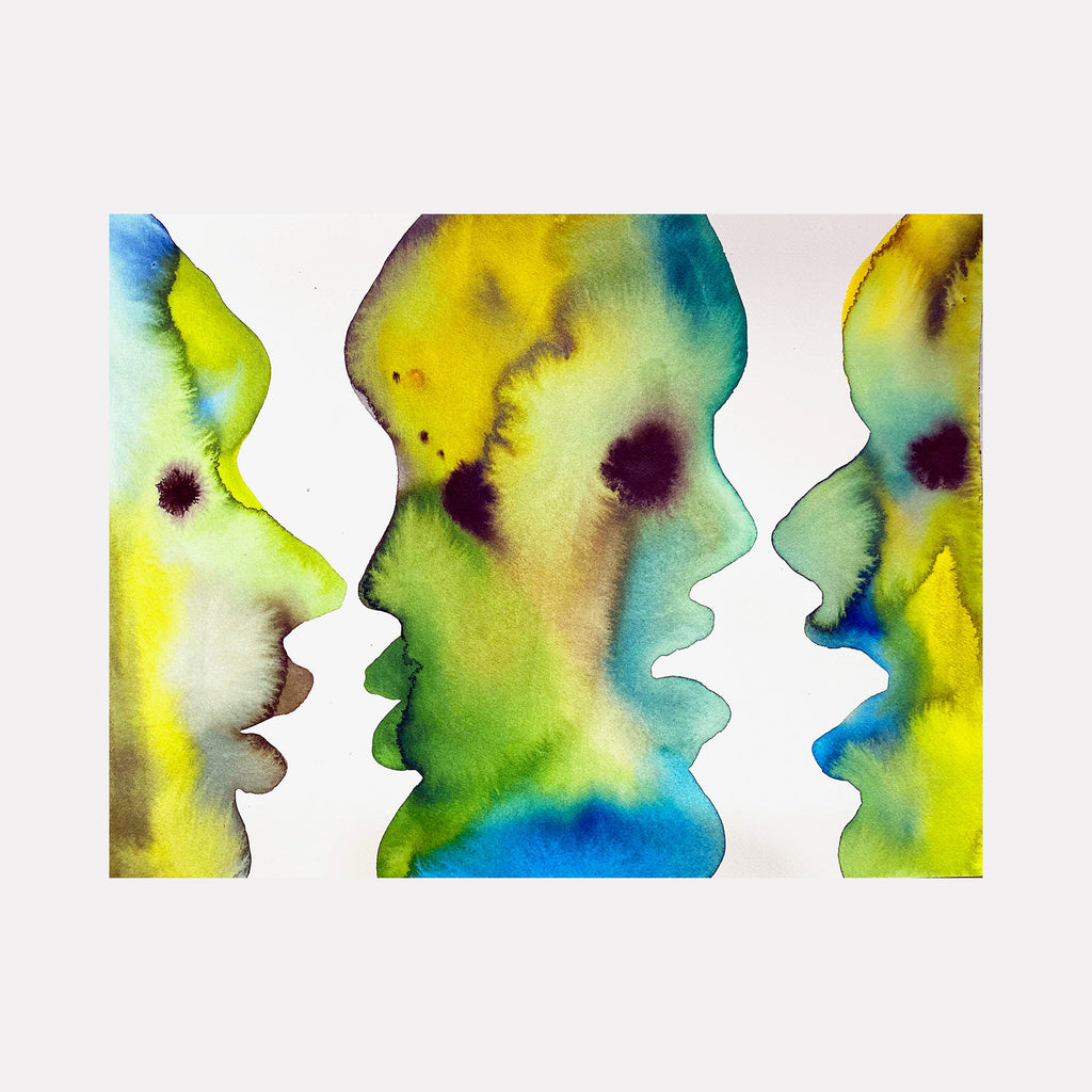 The artwork 'Rubin-esque' features three abstract profile silhouettes in vibrant watercolor-like effects. Flowing gradients of yellow, green, and turquoise blue create ethereal forms, with deep purple spots adding depth. The archival ink on paper creates fluid, organic transitions between colors in a style reminiscent of watercolor techniques by Monica Carrier.