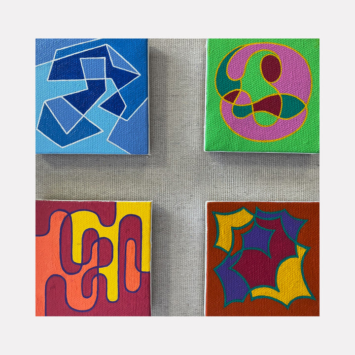 The artwork 'Seasonal Phenomena IV' by Joe Piscopia features four vibrant square canvases arranged in a grid, each showcasing distinct abstract geometric patterns. The composition includes a blue angular design, a green and pink circular motif, a red-orange flowing pattern, and a multicolored angular composition, all painted in acrylic with clean, bold lines - By Joe Piscopia