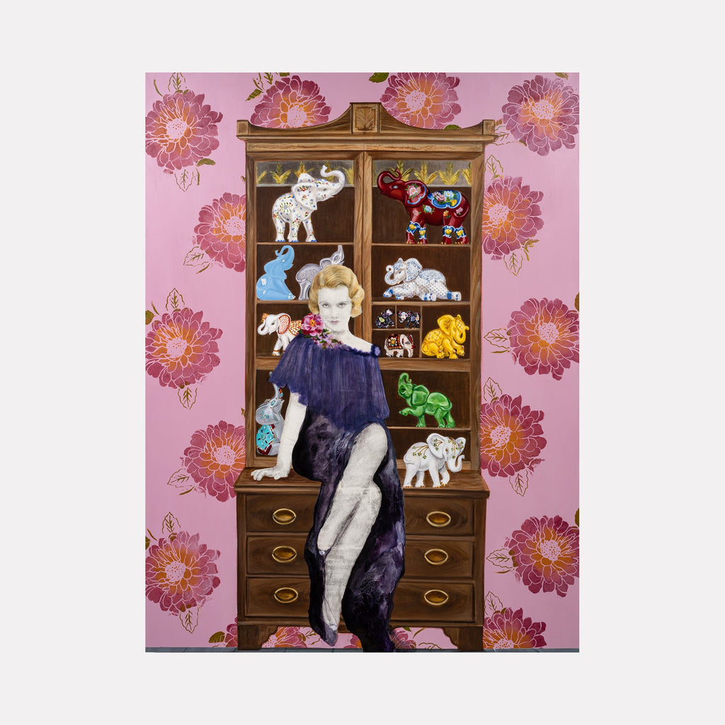 The artwork 'Thirteen Elephants and a Blonde' by Sandra Mack-Valencia features a vintage wooden cabinet displaying colorful decorative elephants against a pink floral wallpaper background. The display case shows whimsical elephant figurines in various colors - white, blue, red, yellow, and green - arranged on shelves. The ornate brown cabinet with drawers is adorned by vibrant pink blooms in a repeating pattern.