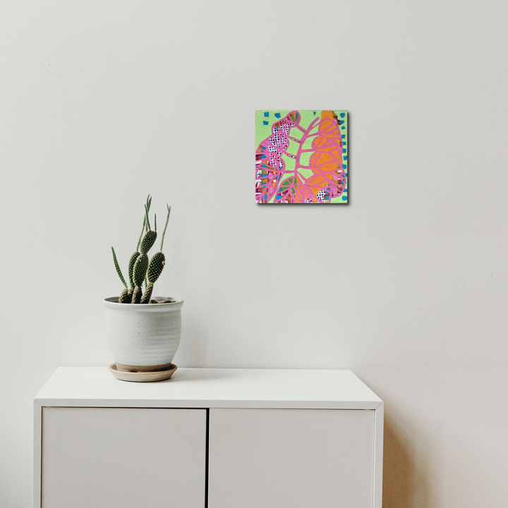 The artwork 'Composition No. 40' by Raul Ortiz features vibrant abstract patterns in coral pink and neon green against a geometric grid background. Bold curved lines and organic shapes create a dynamic composition. The 10x10 inch acrylic painting on gridded paper mounted on cradled panel showcases a modern, energetic design with playful color interactions.