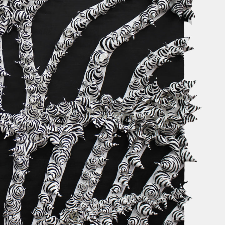 The artwork 'Double Zebraphore' by Seren Morey features striking black and white organic branches with intricate swirling patterns resembling zebra stripes. The abstract composition shows curved lines radiating outward against a dark background, creating a dramatic contrast with textured acrylic relief work and detailed spiral motifs.