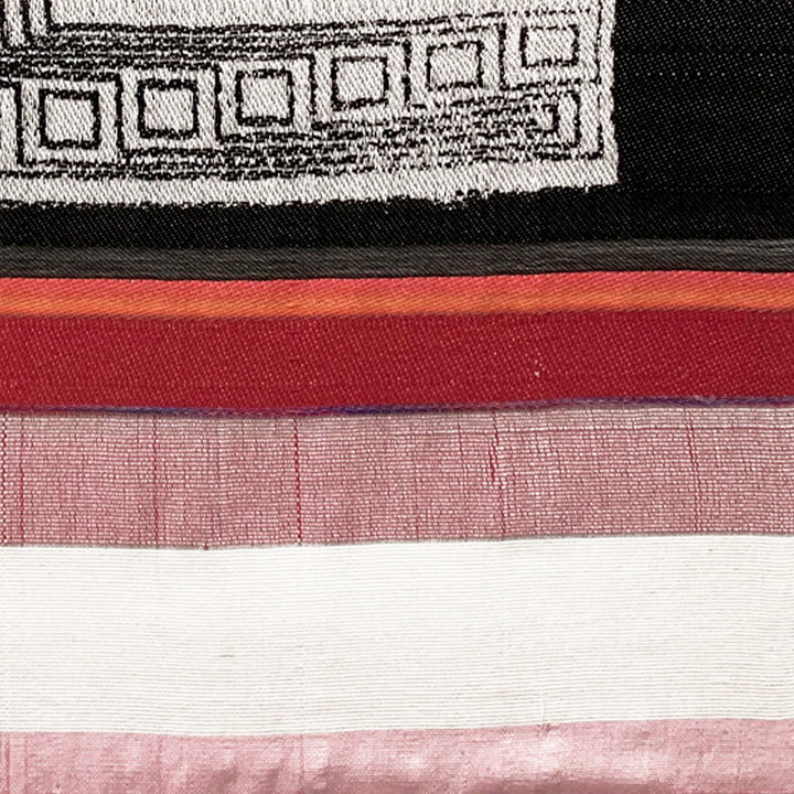 The artwork 'Floating Maize Processor' by Robin Kang features horizontal bands of contrasting colors, from black geometric patterns at top through rich red and burgundy stripes to pale pink and white sections below. Hand-jacquard woven cotton creates subtle texture while hand-dyed wool adds depth to this contemporary abstract textile piece measuring 39x28 inches.