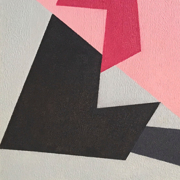 The artwork 'Here I Am' features bold geometric shapes in a minimalist composition, combining sharp black angular forms with soft pink and light gray elements. The oil painting on canvas panel showcases a striking contrast between dark and light tones, creating a dynamic abstract composition with clean lines and precise edges. By Kati Vilim.