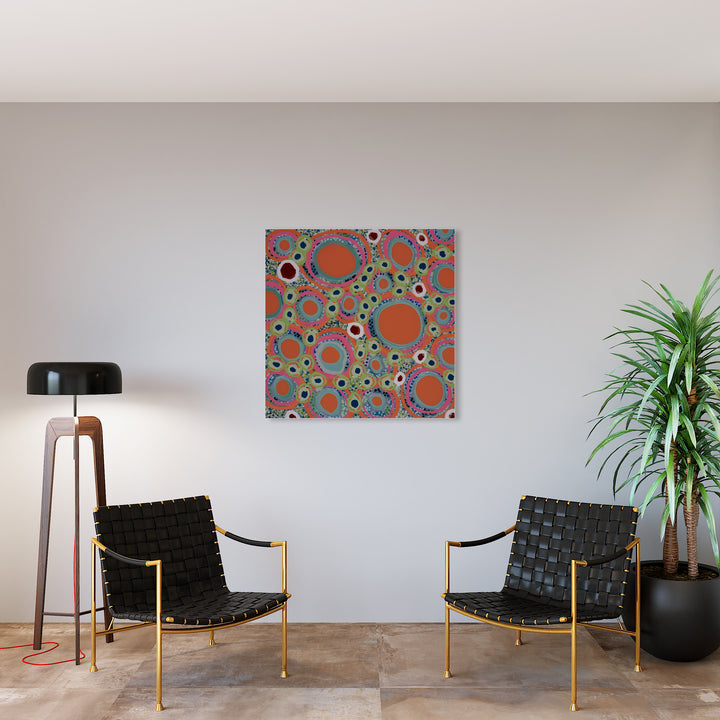 The artwork 'Hot Spot' by Lori Kirkbride features vibrant abstract circles in coral and orange tones against a turquoise background. The acrylic and resin artwork showcases a playful polka dot pattern with varying sizes of spheres, creating a dynamic visual rhythm. The piece has a modern, geometric style with a glossy finish measuring 40x40 inches.