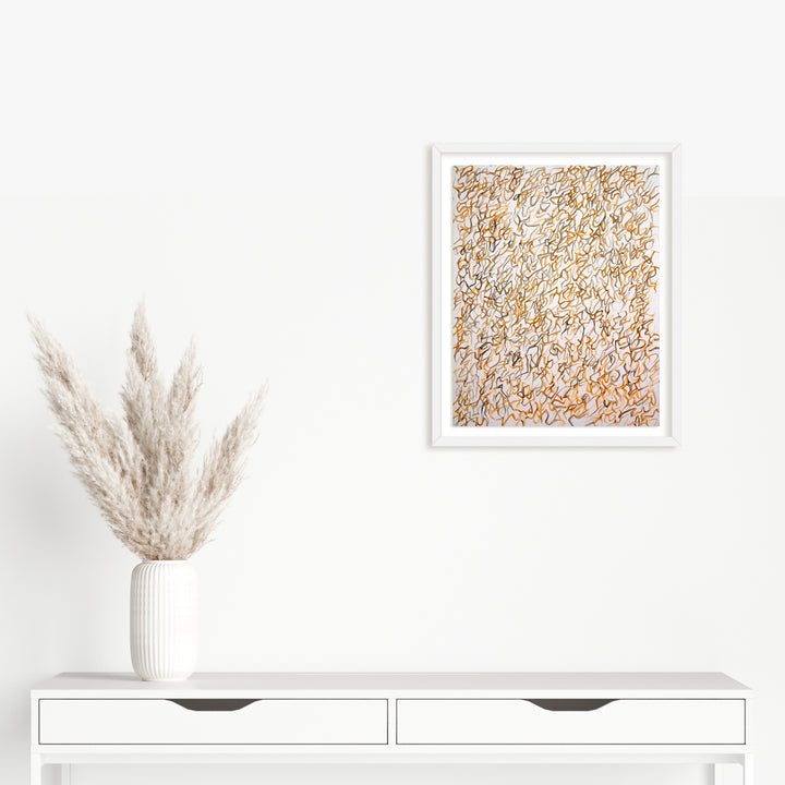 The artwork 'Inside the Next' by Megan Olson features intricate abstract watercolor patterns in soft golden and beige tones, creating a delicate textural maze against white paper. The composition, displayed in a crisp white frame, showcases fluid, organic lines and subtle color variations. 17.5x14 inches watercolor artwork by Megan Olson.