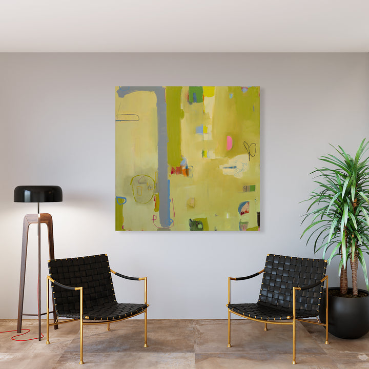 The artwork 'Mariposa' by Janice La Motta features an abstract composition on a 60x60 canvas dominated by luminous yellow-green tones. Subtle blue accents and delicate linear elements create a dynamic interplay across the surface. Random geometric shapes and organic forms float in the ethereal space, with touches of pink and darker hues adding depth. The oil and oil pastel technique creates varied textures and translucent layers. Artwork by Janic