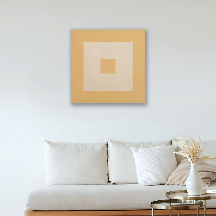 The artwork 'Nostalgia' by Shyun Song features a minimalist geometric composition with concentric squares in warm golden and cream tones. The oil on canvas piece displays a centered design with a small square nested within larger squares, creating a subtle depth effect. The 30x30 inch artwork embodies modern abstract aesthetics with its clean lines and harmonious color palette.