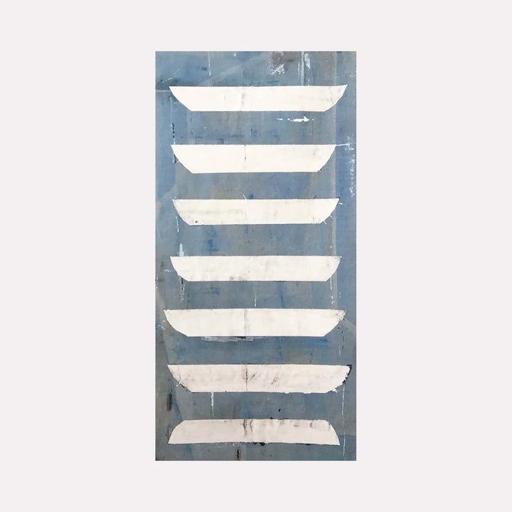 The artwork 'High Seas' by Shira Toren features seven horizontal white abstract boat-like shapes arranged vertically against a muted blue-gray background. The minimalist composition evokes a sense of maritime serenity through its simple geometric forms and weathered texture, printed on a 50x30 inch format. The distressed finish adds depth and character to this contemporary nautical piece by Shira Toren.