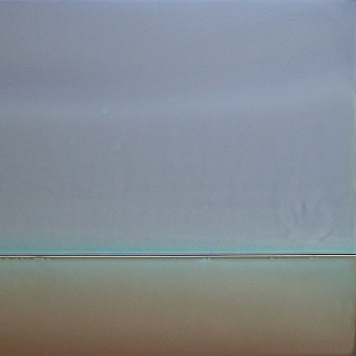 The artwork 'Shadow Light' by Susan English features a minimalist composition divided horizontally by a thin turquoise line. The upper portion displays a misty gray gradient, while the lower section presents a warm taupe hue. Created with tinted polymer on aluminum, the piece exhibits a subtle interplay of colors and atmospheric depth, measuring 34 by 36 inches.