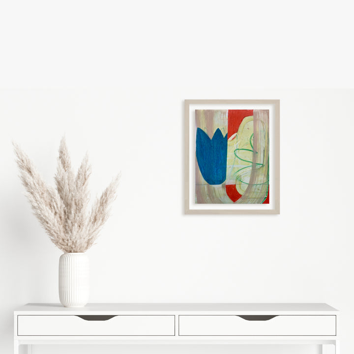 Spring Fling 2 by Janice La Motta: Abstract oil pastel artwork on Yupo paper featuring a bold blue tulip-like form against a beige background, accented with vibrant red and delicate green curved lines. Modern minimalist composition in white frame, showcasing gestural strokes and organic shapes.