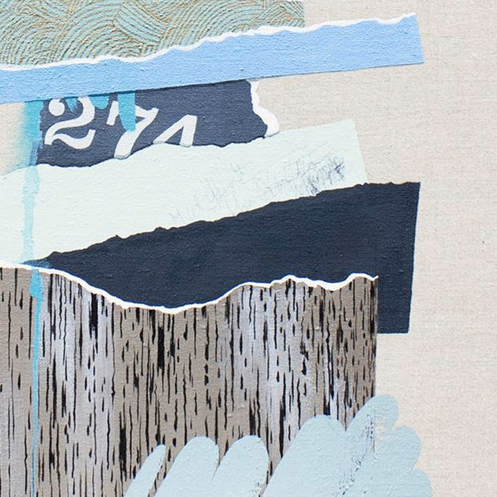 The artwork 'The Rise and Fall No.16' by Lauren Matsumoto features abstract torn paper collage elements in muted blues, grays, and whites. A textured pattern of vertical striations in charcoal gray contrasts with smooth light blue sections and a numerical fragment '274'. The composition creates a layered, geometric effect on clear-primed linen canvas by Lauren Matsumoto.