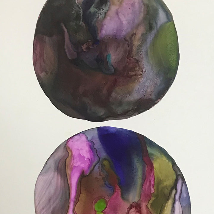 The artwork 'c1' by Arielle Stein features two circular abstract compositions in acrylic ink and watercolor. Each circle displays fluid, marbled effects with swirling patterns in deep purple, vibrant pink, rich navy blue, forest green, and earthy brown tones. The organic flowing textures create a cosmic, ethereal appearance against white paper.